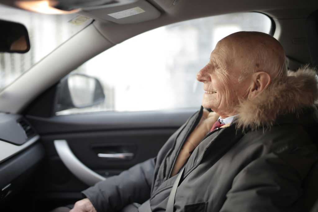 Senior riding in car